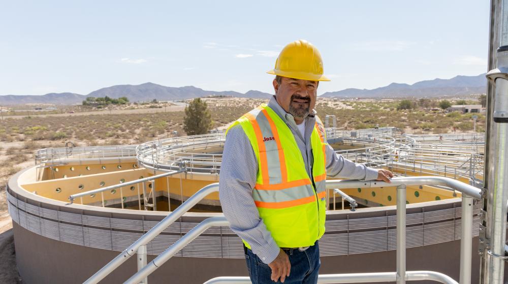 Man standing in front of wastewater treatment facility