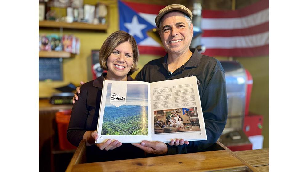 woman and man holding book at coffee shop