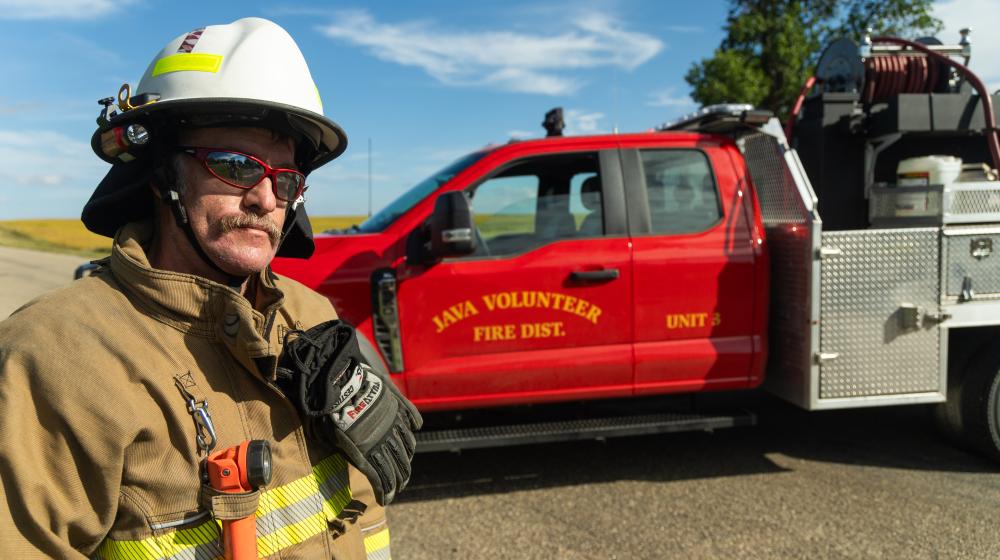 Firefighter in front of fire truck