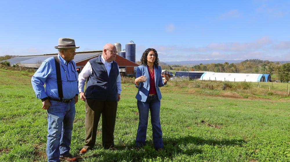 Richard Perkoski (left), owner of Main Street Milk LLC, Bob Morgan (middle), state director of U.S. Department of Agriculture (USDA) Rural Development in Pennsylvania, and USDA Deputy Secretary of Agriculture Xochitl Torres Small, speak to a small crowd at the Main Street Milk Farm in Somerset, Pa., on Nov. 3, 2024.