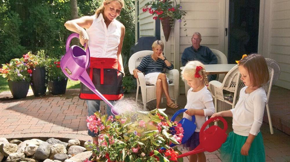 Dramm Executive Vice President and Corporate Relations Officer Heidi Dramm Becker waters plants with family