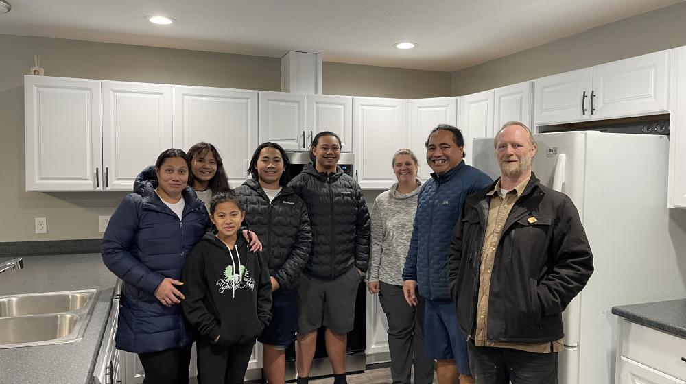 Tai Lepule and his family stand proudly in their new home’s kitchen with USDA Rural Development Area Director Amy Milburn and RurAL CAP Construction Manager Chris Blanchard. In November 2022, USDA Rural Development invested $734,714 with Rural CAP to help 18 families build energy efficient homes in Soldotna, Alaska