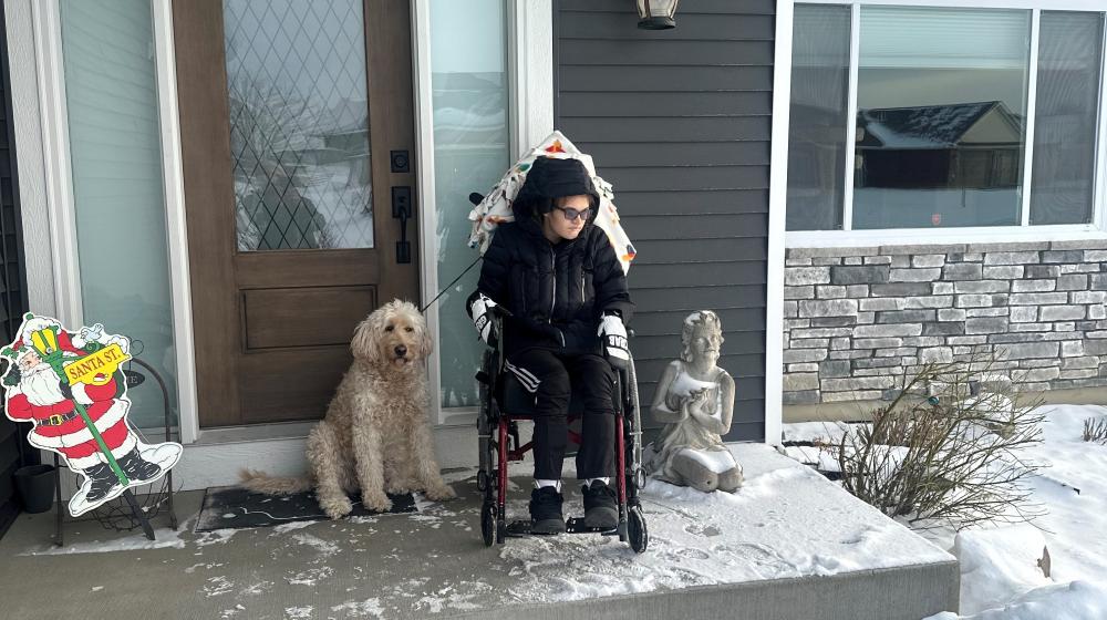 Aliesha Larson's daughter, Ali, and dog sit outside their new, one-level home in Chisago City. 