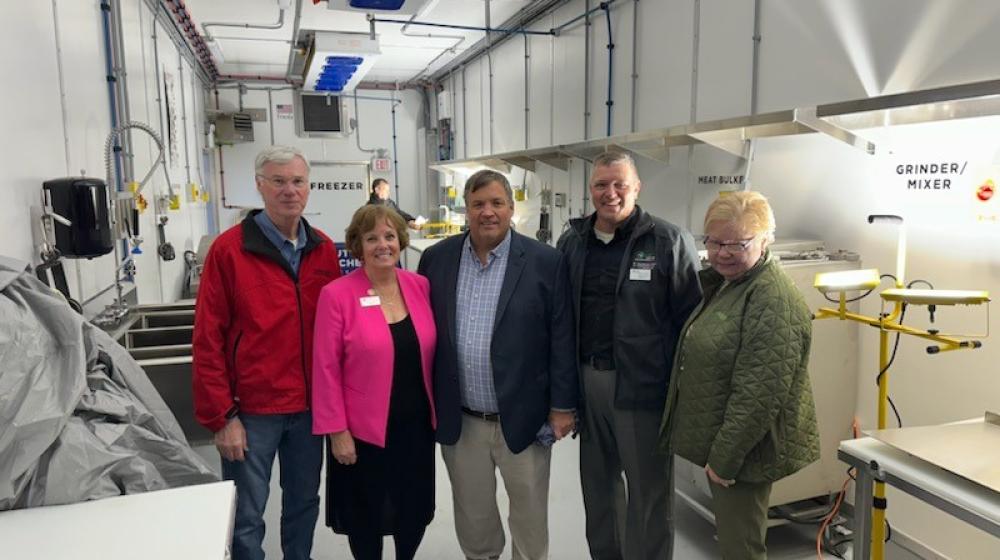 Officials gather for the grand opening of Central Lakes College's new mobile meat processing facility. 