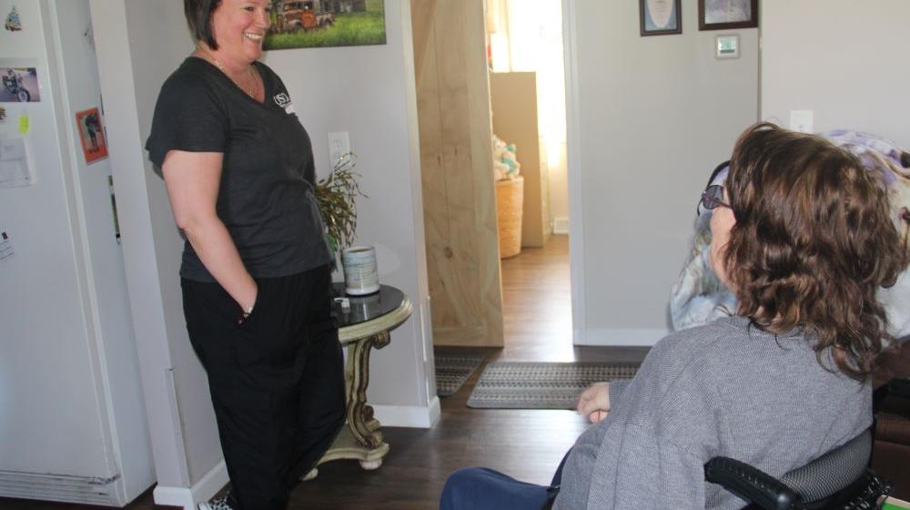 Two people talk to each other in a house