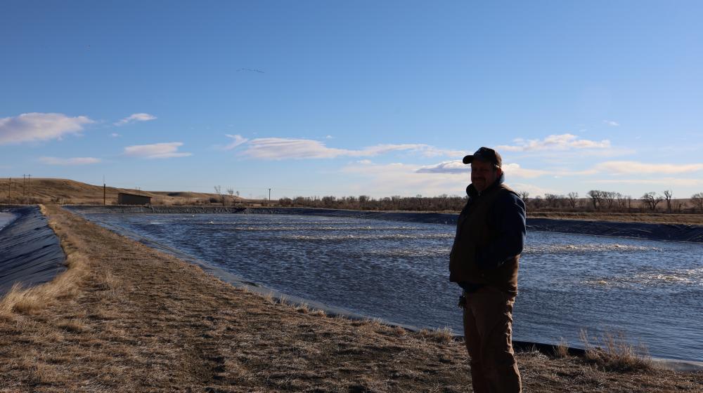 Man standing next to lagoon