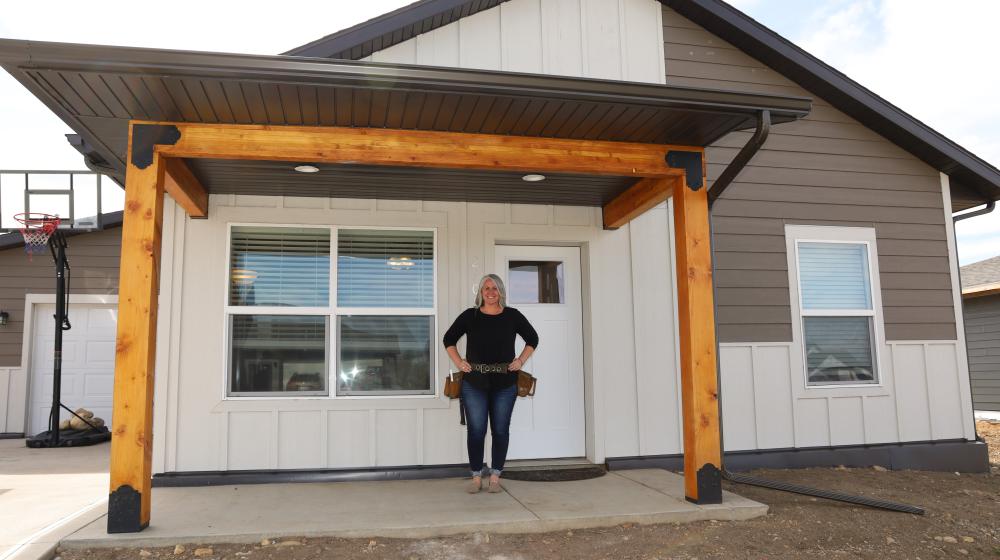 Woman in front of house