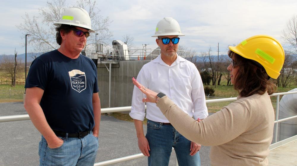 Town officials conferring with an RD staffer at the wastewater treatment plant site.
