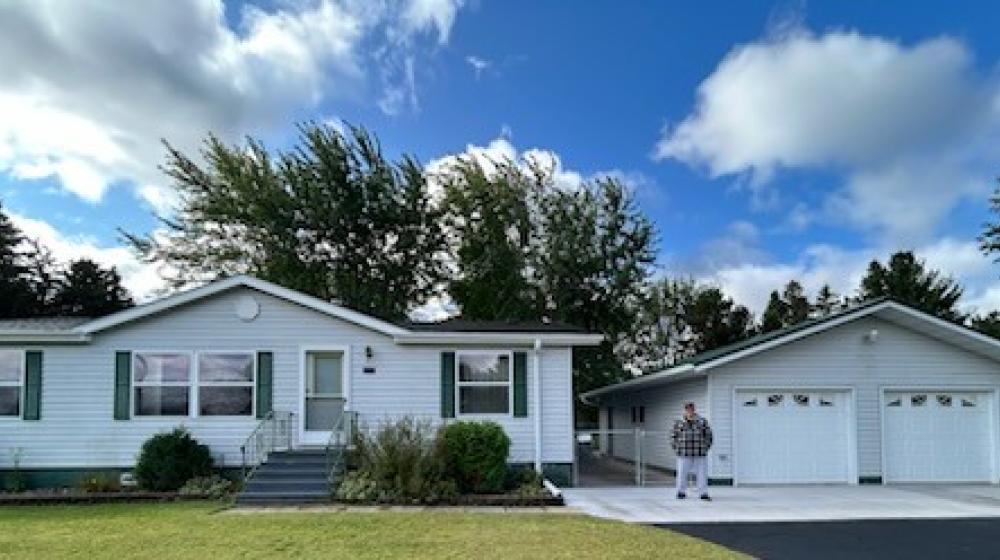Boyceville homeowner David Jacott stands in front of his home.