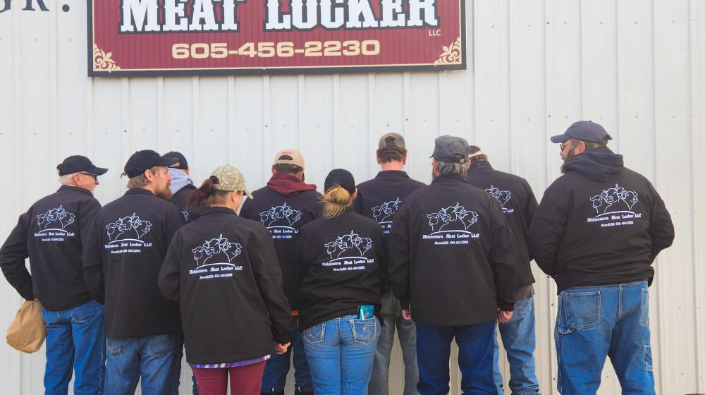 Midwestern Meat Locker staff show off their new jackets in 2022.