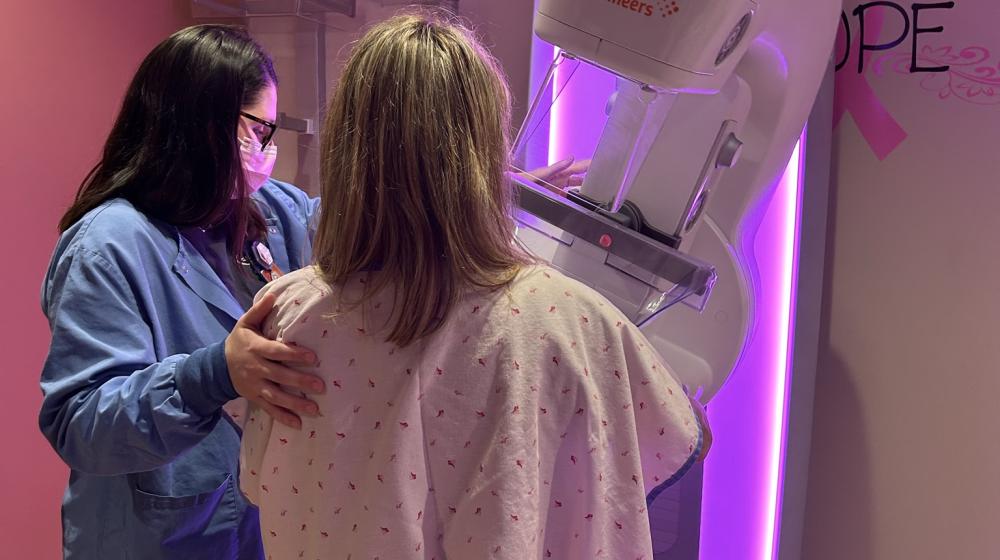 Hospital staff assisting patient with mammography screening