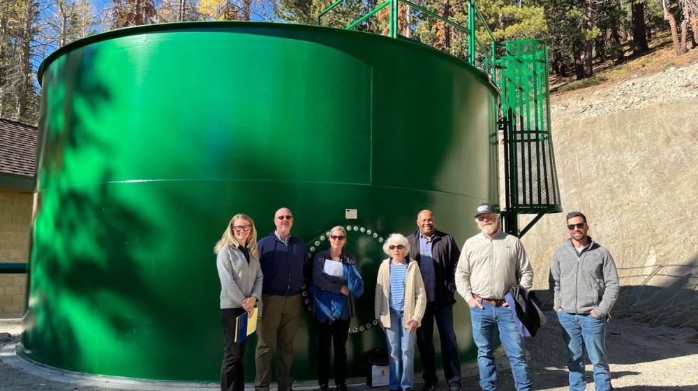 7 people standing in front of water tank
