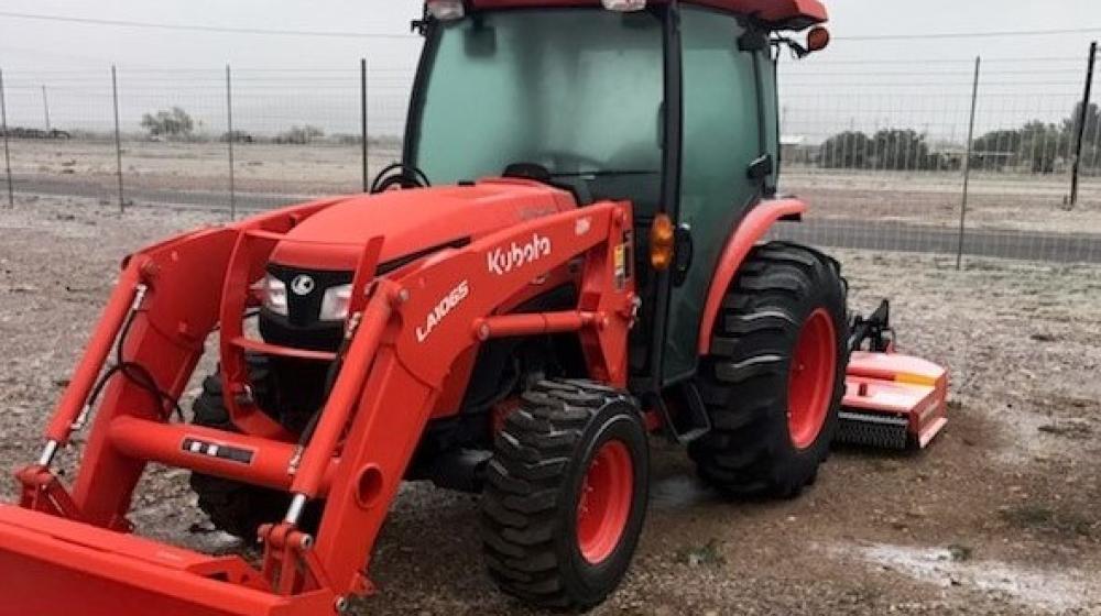 The new tractor with mower and front-end loader.