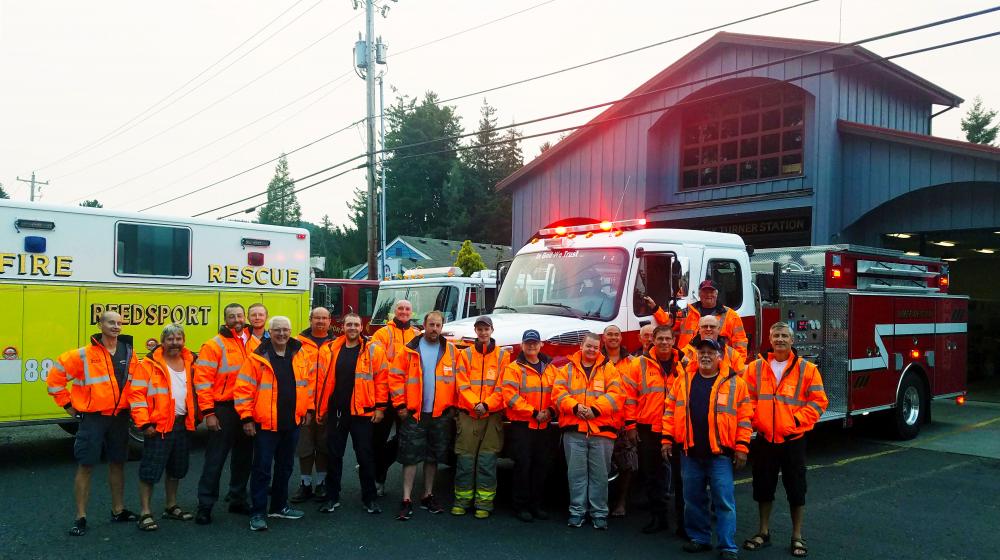 The volunteer firefighters in Reedsport, Oregon, gather around their new fire pumper truck as it is delivered.