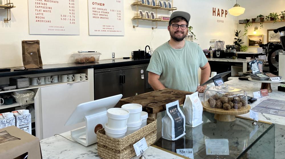 Mallory behind the counter at Happ Coffee.