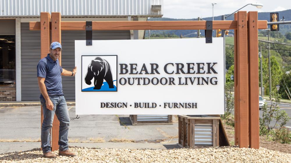 Brian Mininger with the Bear Creek sign