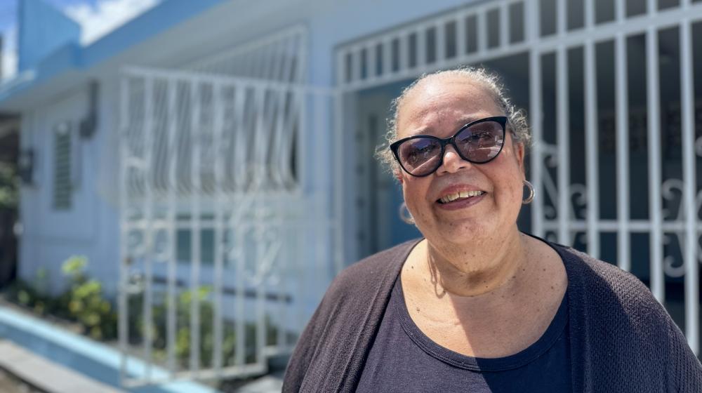 Iris standing in front of her house in Loiza, Puerto Rico