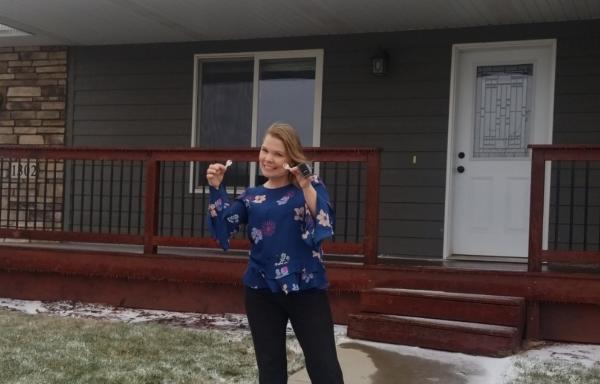 Crystal Dahl in front of her new home. 