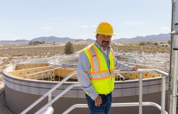 Man standing in front of wastewater treatment facility
