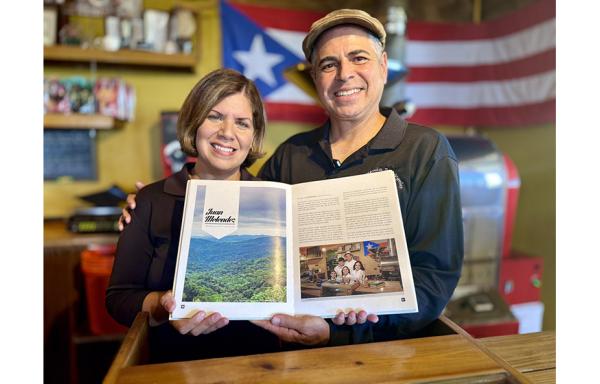 woman and man holding book at coffee shop