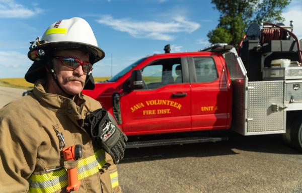 Firefighter in front of fire truck