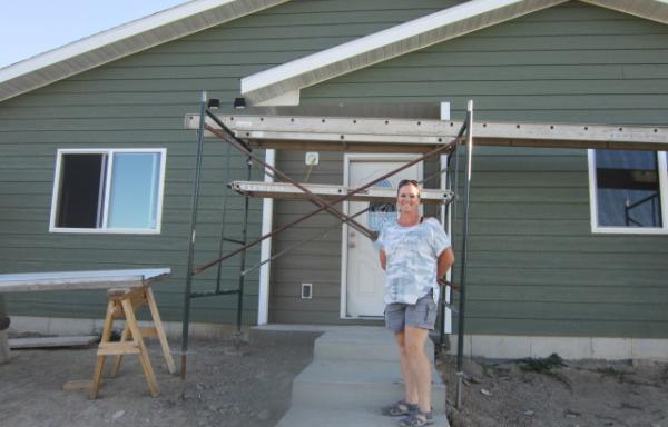 Lori Bonifay in front of her home