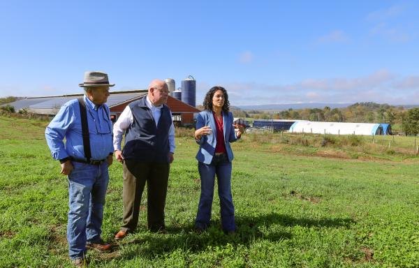 Richard Perkoski (left), owner of Main Street Milk LLC, Bob Morgan (middle), state director of U.S. Department of Agriculture (USDA) Rural Development in Pennsylvania, and USDA Deputy Secretary of Agriculture Xochitl Torres Small, speak to a small crowd at the Main Street Milk Farm in Somerset, Pa., on Nov. 3, 2024. 