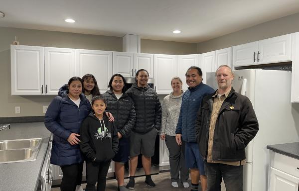 Tai Lepule and his family stand proudly in their new home’s kitchen with USDA Rural Development Area Director Amy Milburn and RurAL CAP Construction Manager Chris Blanchard. In November 2022, USDA Rural Development invested $734,714 with Rural CAP to help 18 families build energy efficient homes in Soldotna, Alaska