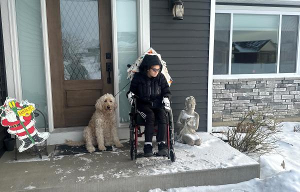 Aliesha Larson's daughter, Ali, and dog sit outside their new, one-level home in Chisago City. 