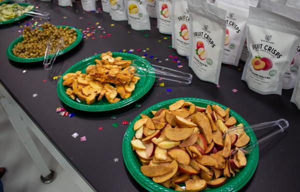 Freeze-dried fruit chips in plates on a table laid out for sampling. 