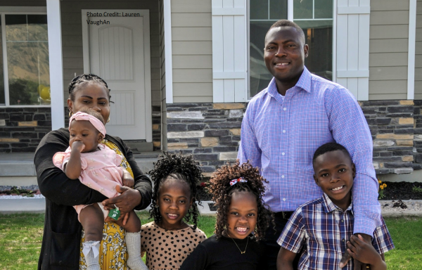 Francis & Nicole Badibanga in front of their new home with their four children