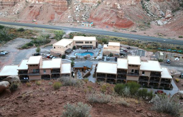 Aerial view of Bluff Dwellings rooftops with red cliffs in background.