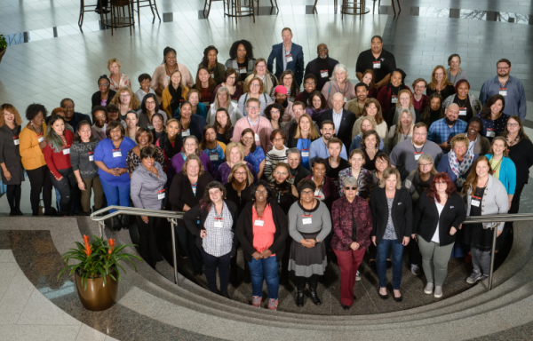 Cooperative developers and members of home care cooperatives gather at the National Home Care Cooperative Conference. Group of smiling people standing in a large open room.