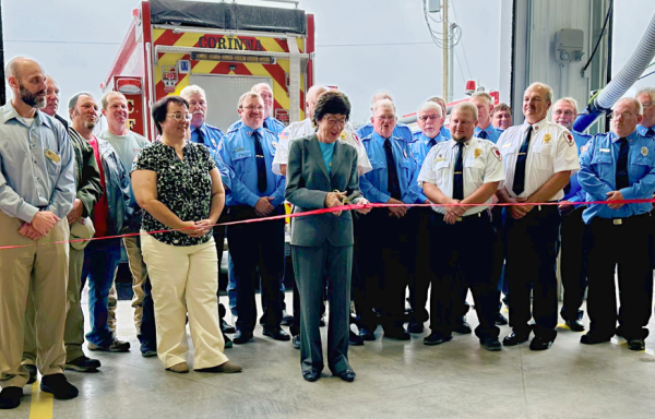 Senator Susan Collins stands with members of the Corinna Fire Department and others at the ribbon cutting ceremony for the new fire station. 