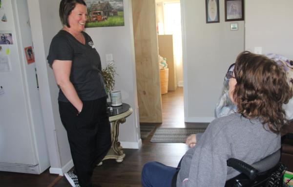 Two people talk to each other in a house