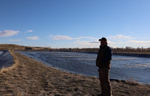 Man standing next to lagoon