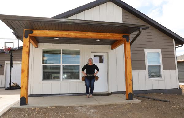 Woman in front of house