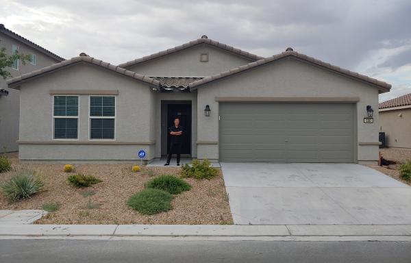 A woman stands outside her home in Nevada.