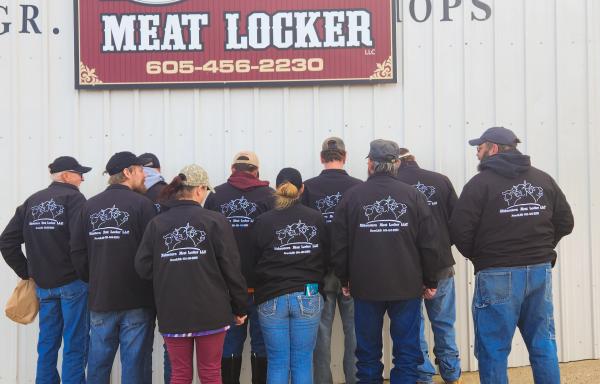 Midwestern Meat Locker staff show off their new jackets in 2022.