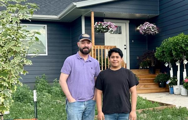 Joe Barb and his son outside their home in Rapid Valley