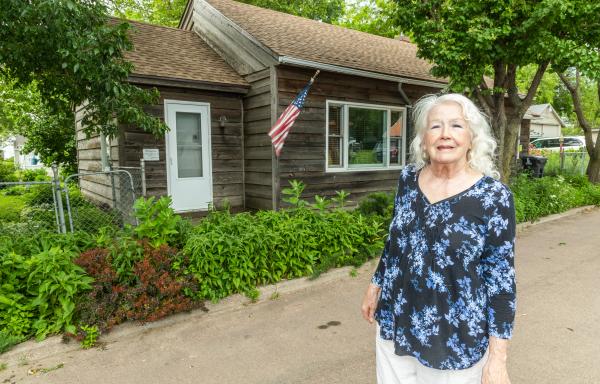 Jolene stands outside her home.
