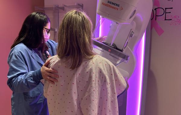 Hospital staff assisting patient with mammography screening