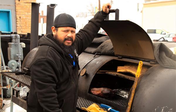 Ruben Lopez Opening Smoker to show meat cooking inside.