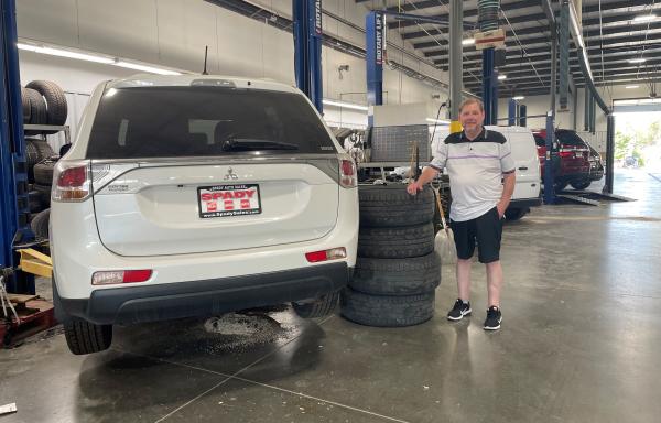 Todd Spady stands next to a vehicle in his family business