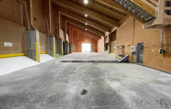 Large, cavernous warehouse with bins of fertilizer. 