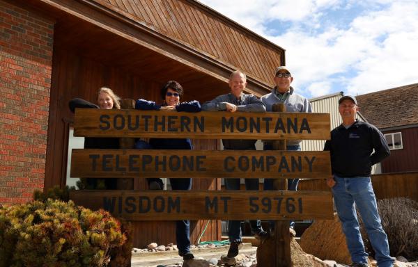 People standing behind a sign