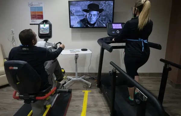 Two patients exercise in the telehealth cardio rehab room at Benson Hospital. 