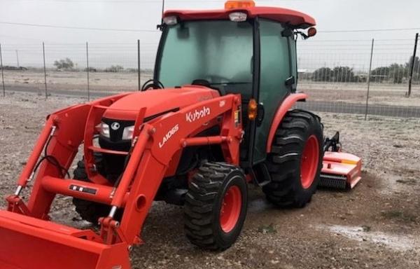 The new tractor with mower and front-end loader.