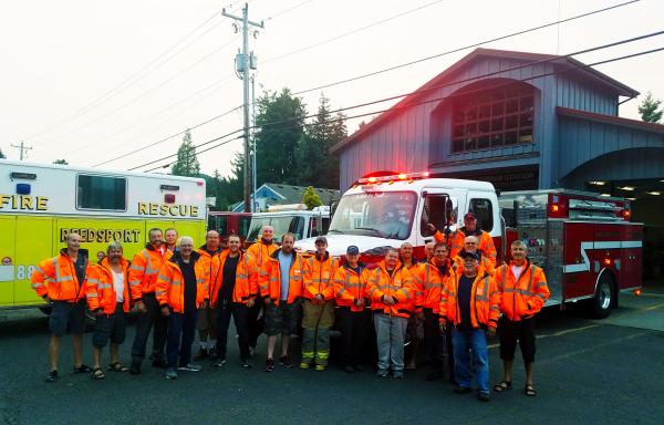 The volunteer firefighters in Reedsport, Oregon, gather around their new fire pumper truck as it is delivered.