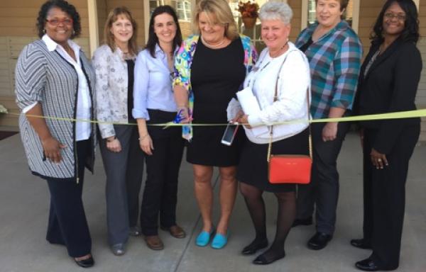 Members of Virginia Housing Development Authority, Surber Development LLC, and USDA Rural Development Virginia gather to cut ribbon at Lily Ridge Apartments ribbon cutting ceremony.